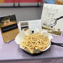 Interpretation of As I Daying. Frying pan with a pile of french fries on. Book pages line the frying pan The edible book is titled As I Lay Frying.