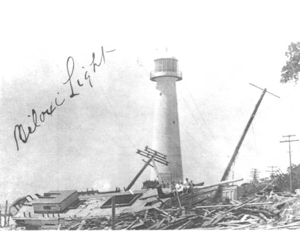 Lighthouse in the center of the image surrounded by a crashed boat and other debris. On the left side, Biloxi Light is written.  
 
