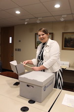 Photo of Trublood looking through a box of items in the collection.